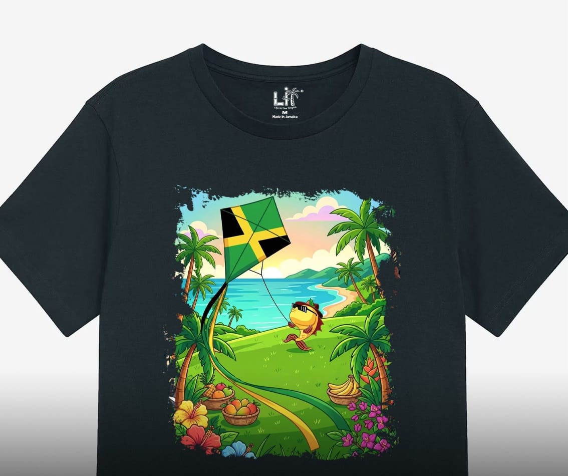 A black tee printed with a fish character flying a Jamaican flag kite on the coast